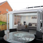 White Bifold Conservatory with doors open.